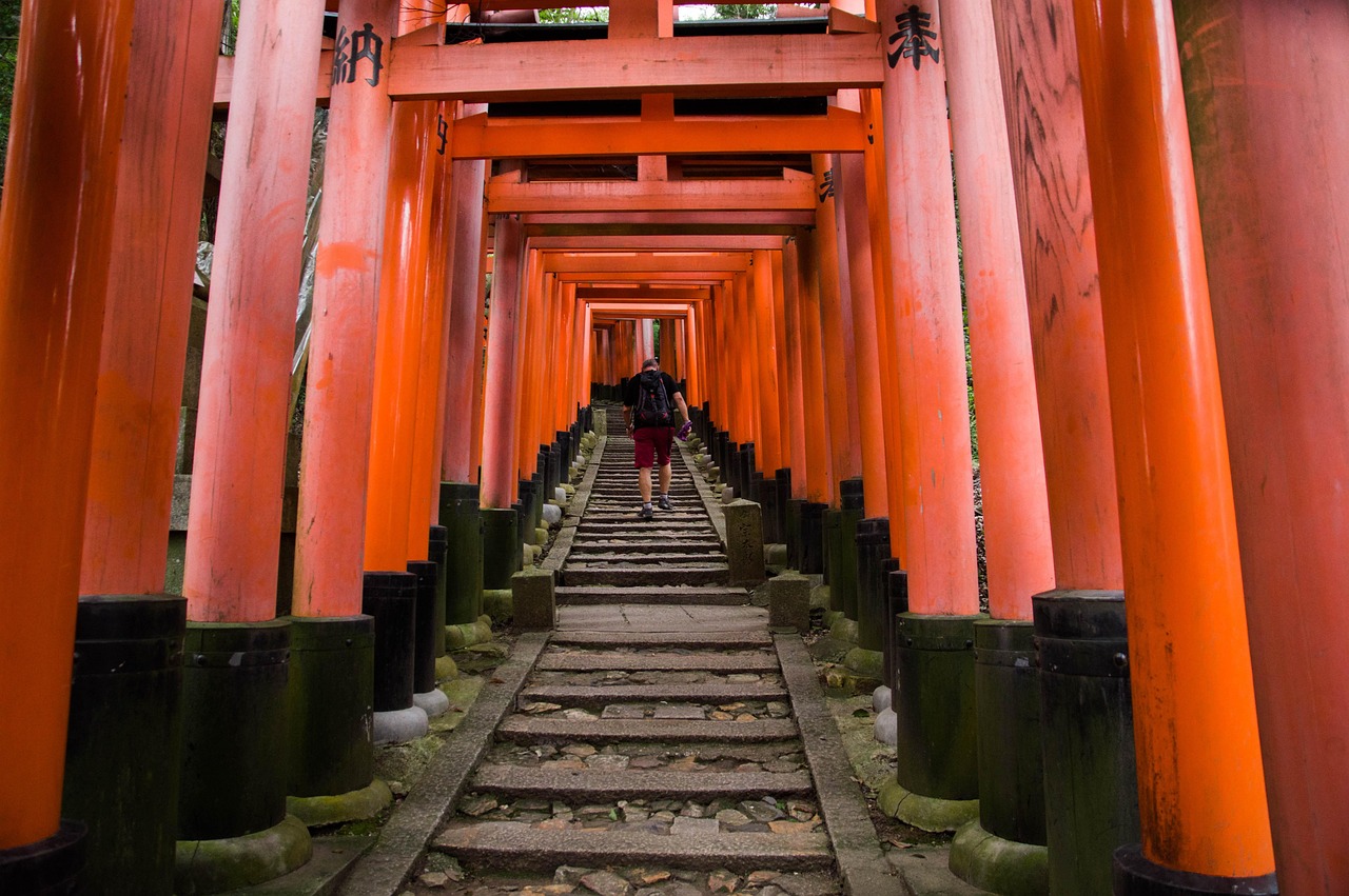 The iconic vermilion torii gates of Fushimi Inari Shrine in Kyoto — a must-see among the most spiritual and photogenic places to visit in Japan Fushimi Inari Shrine's endless red torii gates winding up the forested hillside in Kyoto