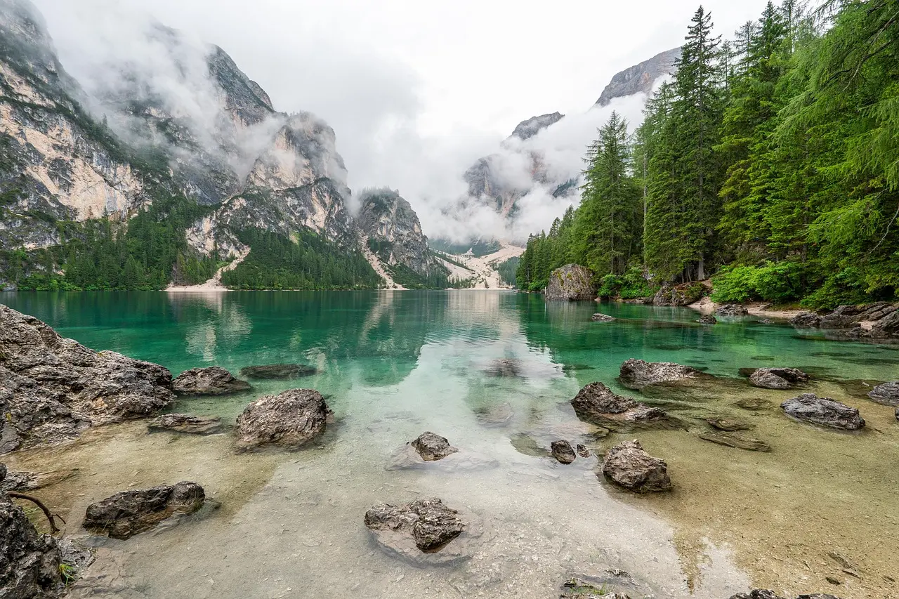Stunning alpine panorama of Interlaken — a serene and adventurous European honeymoon destination Panoramic view of Interlaken with snow-capped Alps, turquoise lakes, and lush green meadows