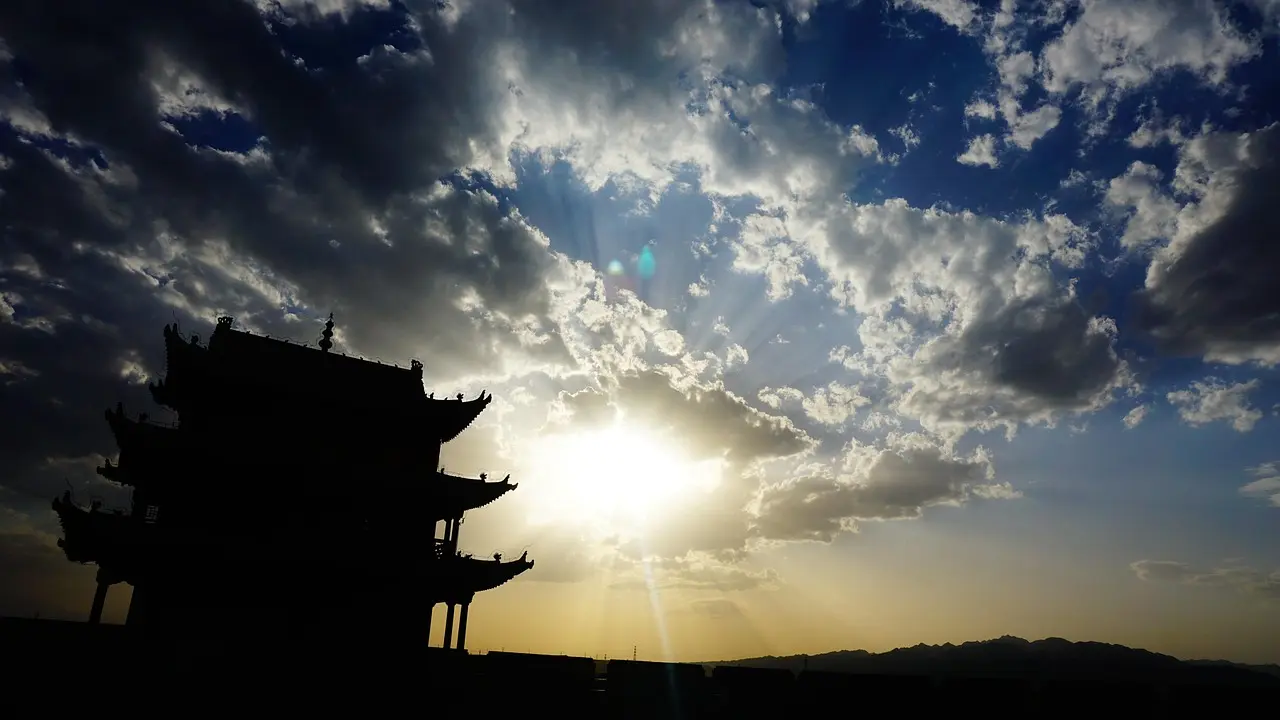 Silhouette of a traveler gazing at sunrise over the Great Wall of China