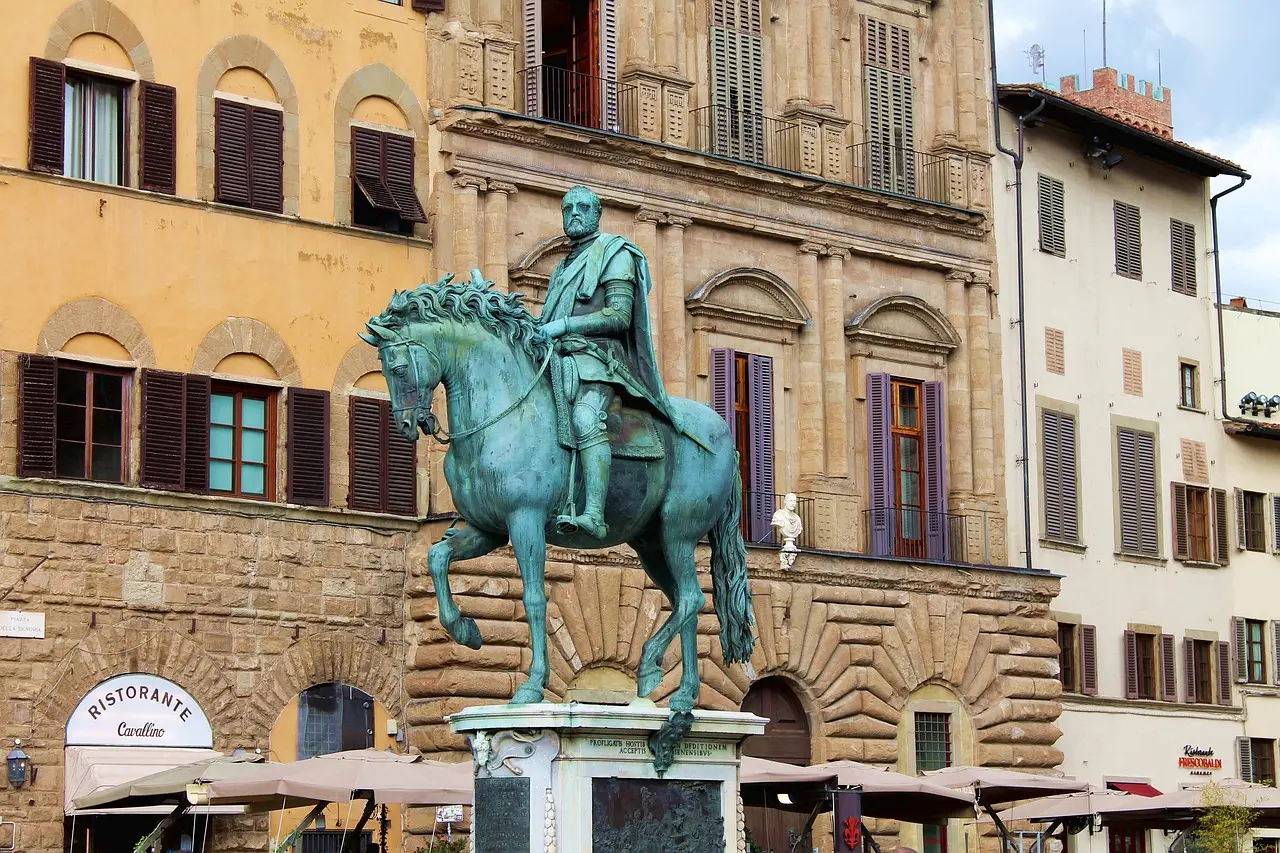Traveler sitting on a bench in Piazza della Signoria sketching the Palazzo Vecchio