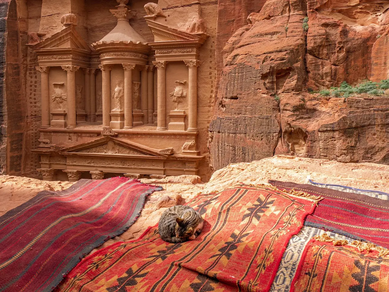 The Treasury glows in amber light — a dramatic testament to why visiting ancient landmarks in Jordan delivers unforgettable visual and historical impact. Al-Khazneh (The Treasury) in Petra illuminated by soft afternoon light