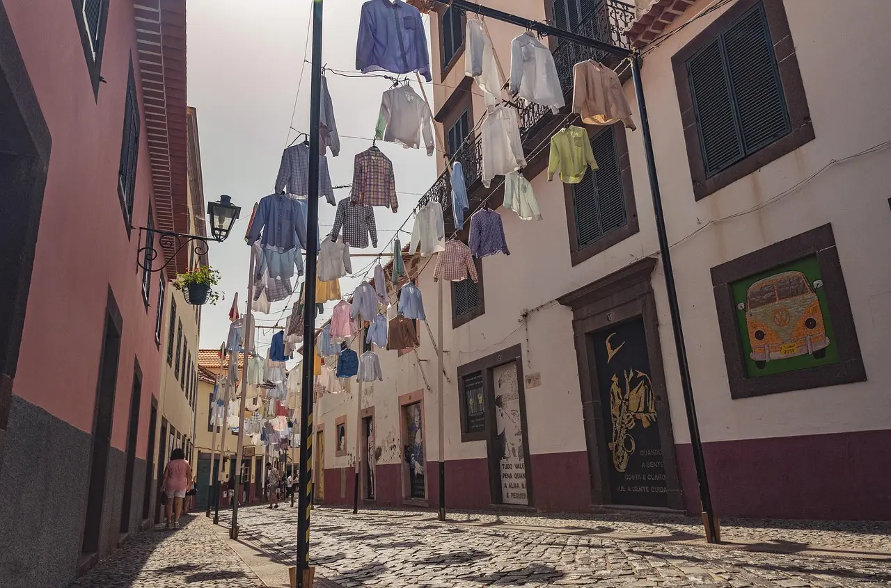 Quiet street in Florence's Oltrarno district with artisan workshops and laundry hanging above
