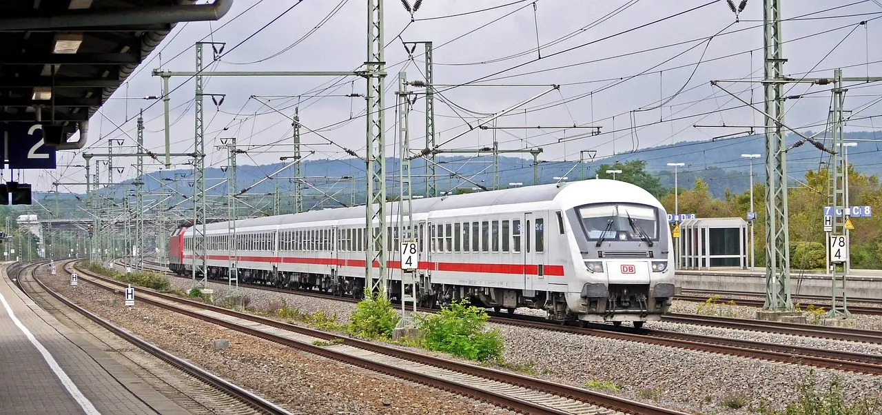Modern ICE high-speed train speeding through German countryside with green fields