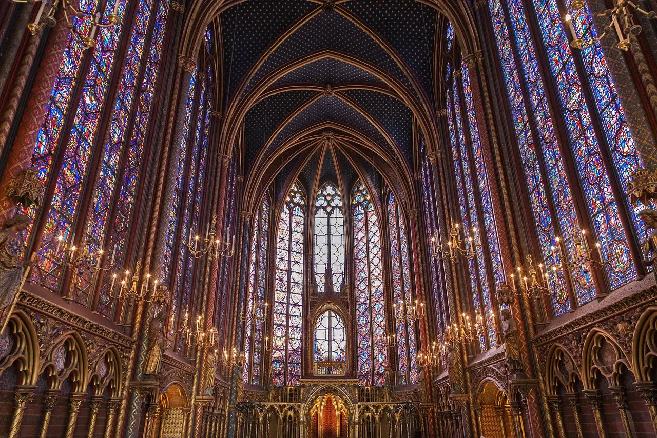 Colorful stained glass windows inside Sainte-Chapelle at sunset