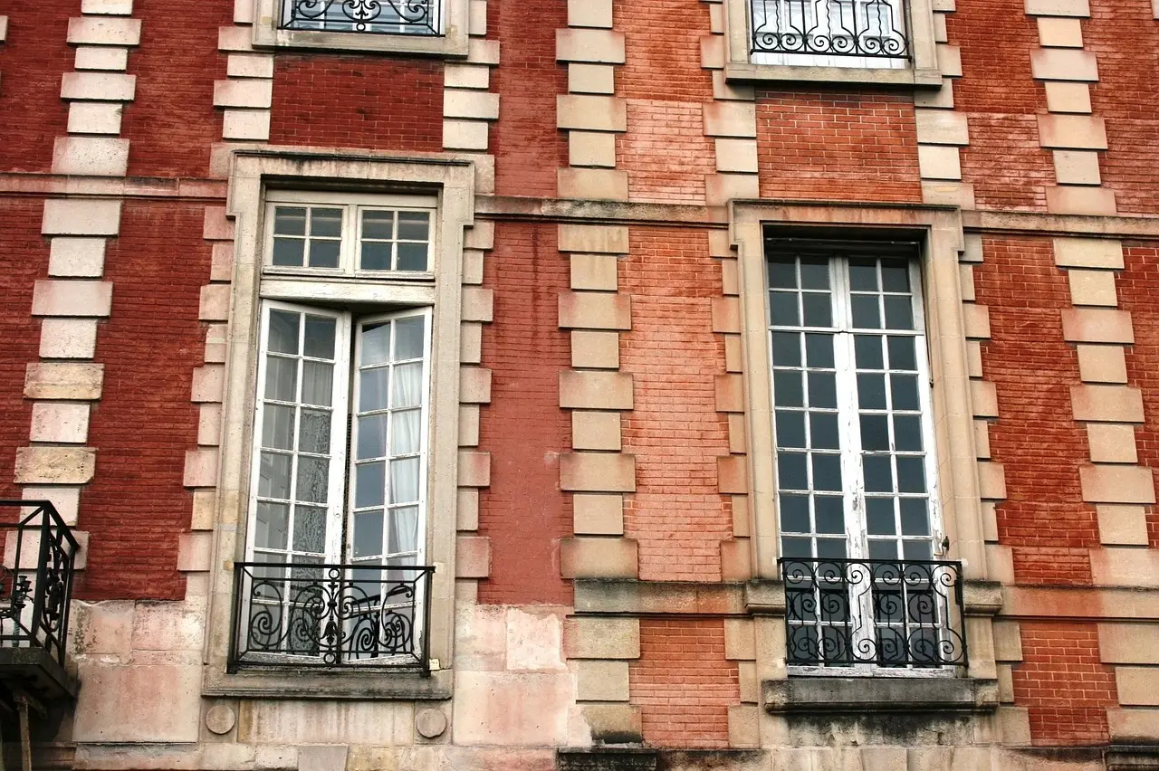 Historic red-brick square with arcades in Place des Vosges, Marais