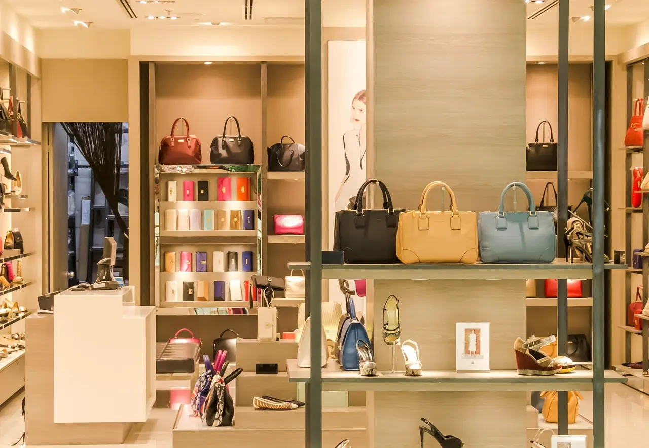Historic Parisian retail space demonstrating how VAT refunds and sophisticated shopping consumption intersect in European elegance Elegant Parisian department store interior with ornate ceiling, escalators, and shoppers browsing luxury accessories