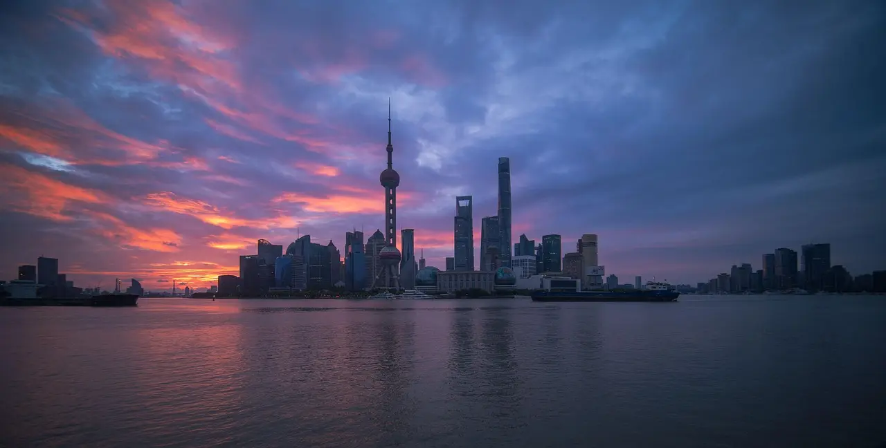 The Bund at twilight: A dramatic skyline that frames Shanghai’s layered identity as a premier shopping destination for travelers Historic neoclassical buildings of The Bund reflected in Huangpu River, juxtaposed with modern towers across the water