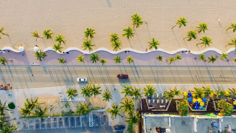 Aerial view of Thailand's coastline with white sand beaches and palm trees