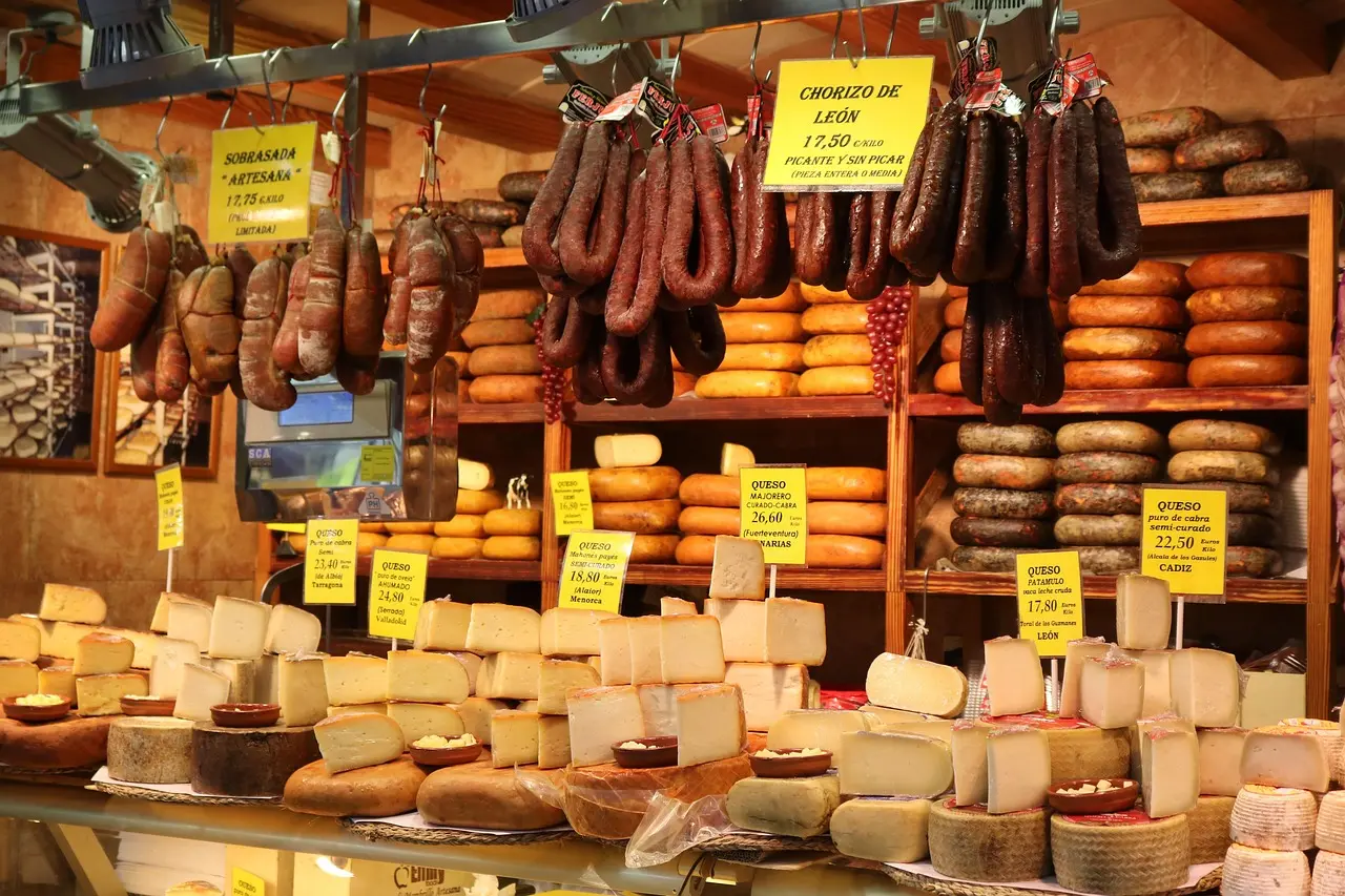 Mercado de San Miguel in Madrid: A stylish, curated shopping destination for travelers who appreciate gastronomy and design Elegant iron-and-glass interior of Mercado de San Miguel with gourmet food stalls and hanging hams