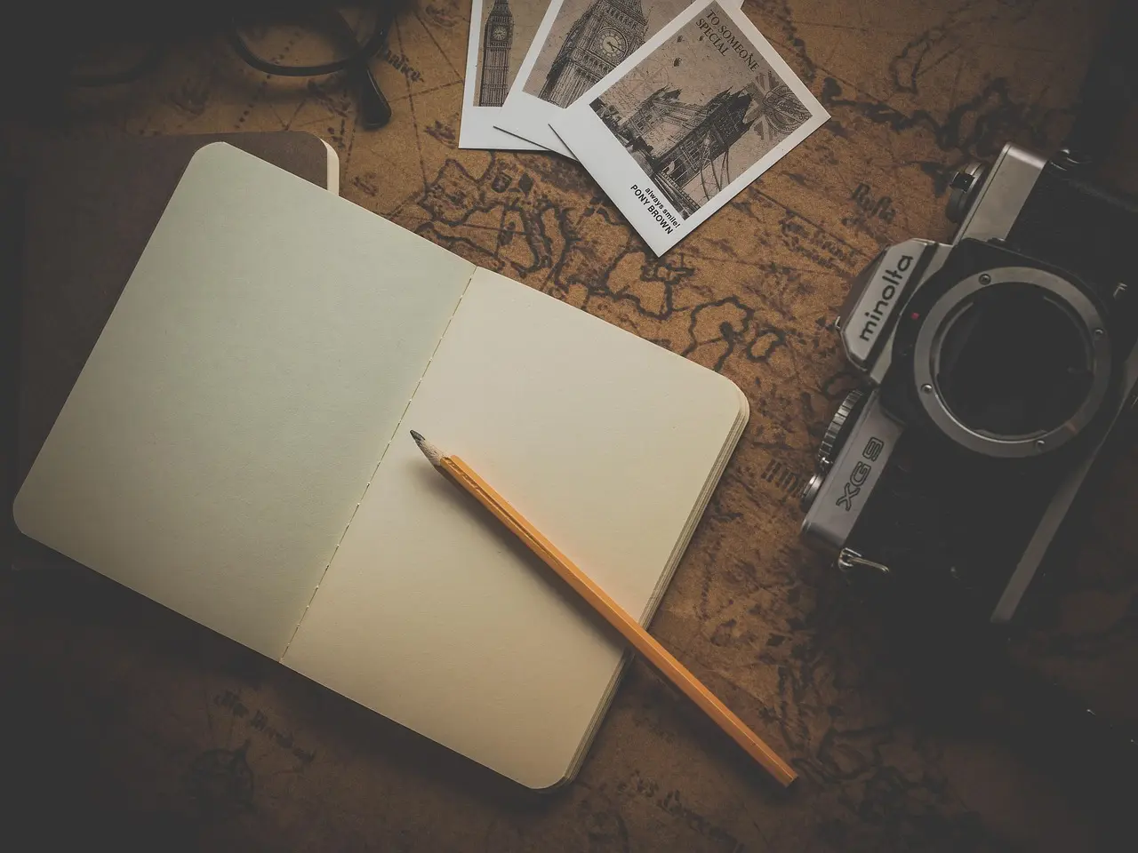 Thoughtful preparation empowers meaningful, low-impact appreciation of natural scenery anywhere in the world A minimalist travel kit laid out on a wooden table: refillable water bottle, field journal, binoculars, reusable utensils, and a small plant guidebook