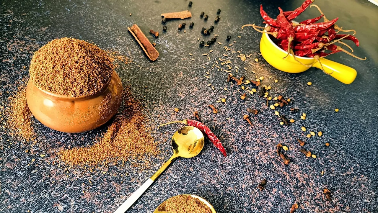 Marrakech stands out among food travel destinations for its aromatic spices and time-honored authentic local cuisine Moroccan chef stirring a copper tagine pot filled with lamb, apricots, and almonds over open flame
