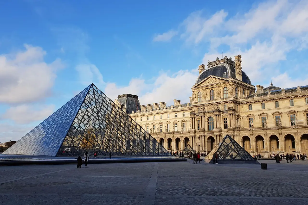 Early morning view of Louvre Pyramid with few visitors