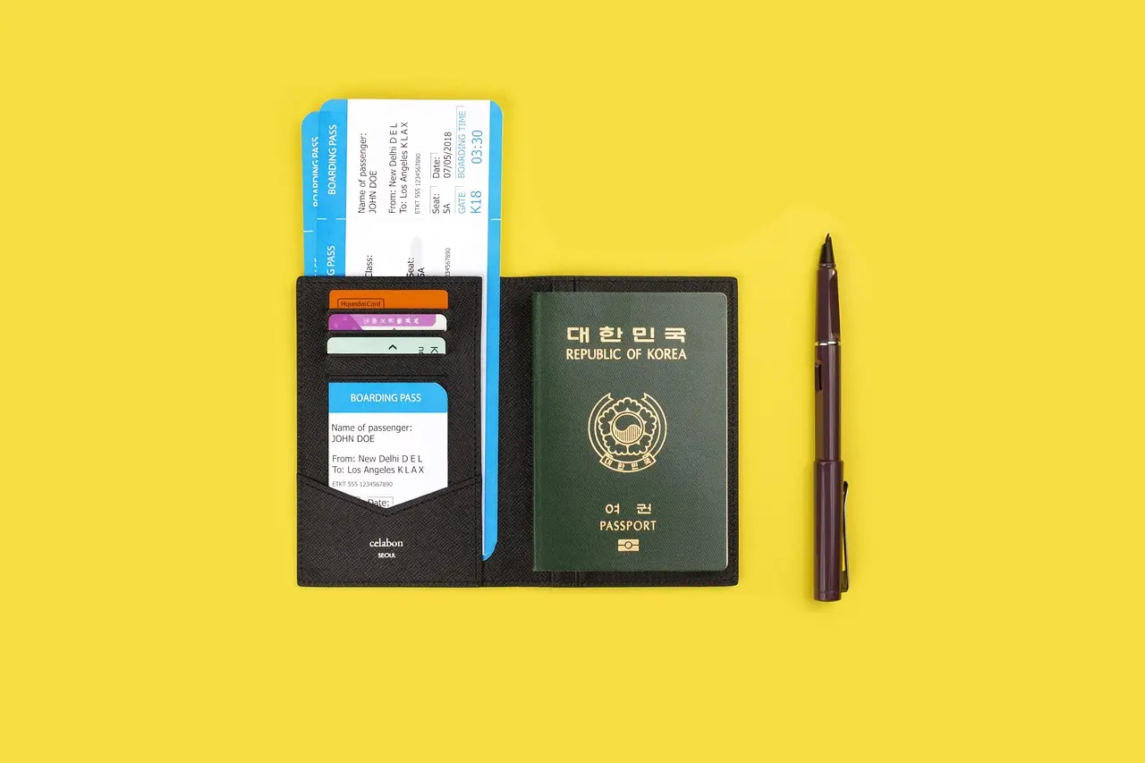Organized traveler preparing for seamless shopping consumption and VAT refund process using digital tools and physical documents Traveler organizing receipts, passport, and smartphone showing tax-refund app interface on hotel desk