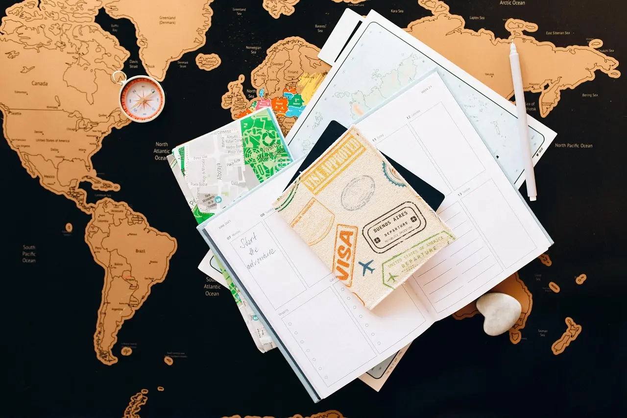 Planning intentional food travel starts with curiosity — mapping ingredient origins, harvest calendars, and community-led experiences ensures depth over decoration. Handwritten itinerary notebook beside rustic map, wooden spoon, and dried herbs on linen tablecloth