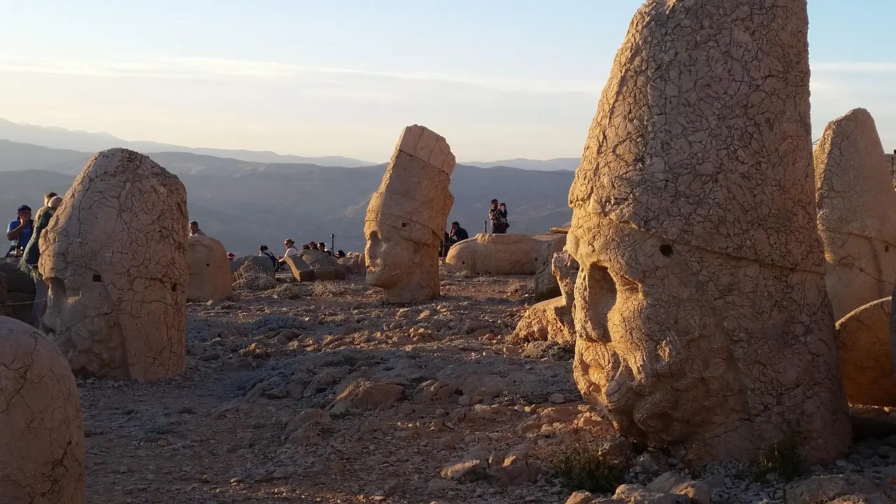 Colossal stone heads on Mount Nemrut bathed in sunrise glow
