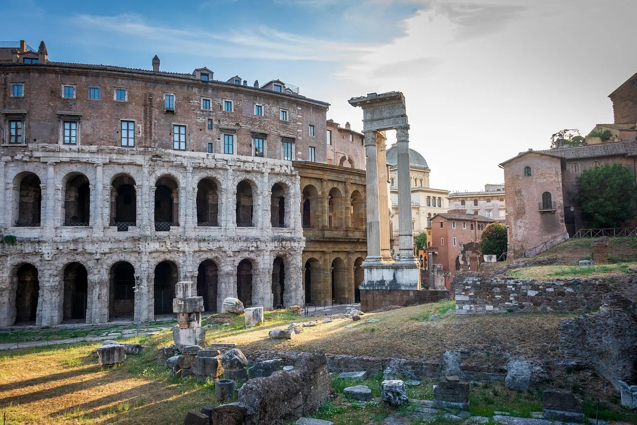 Visitor standing on reconstructed Colosseum arena floor looking down into underground chambers