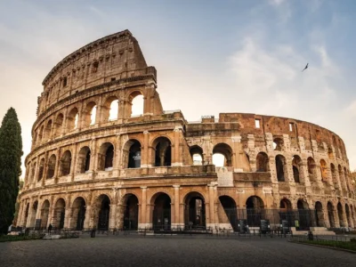 Aerial view of Rome showing ancient ruins and modern rooftops at golden hour