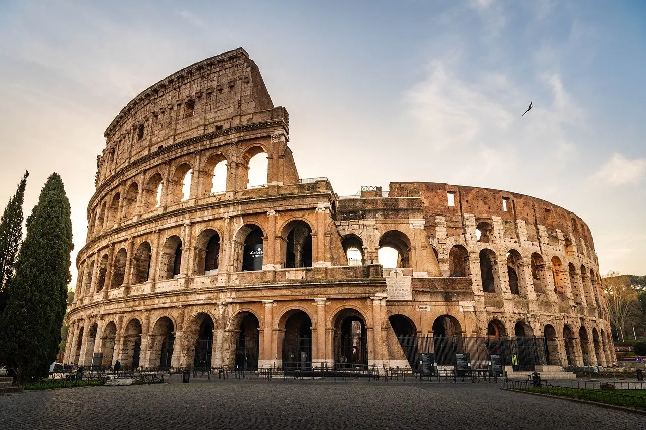 Aerial view of Rome showing ancient ruins and modern rooftops at golden hour