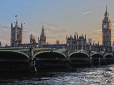 Aerial view of central London with Big Ben, Thames River, and red double-decker buses