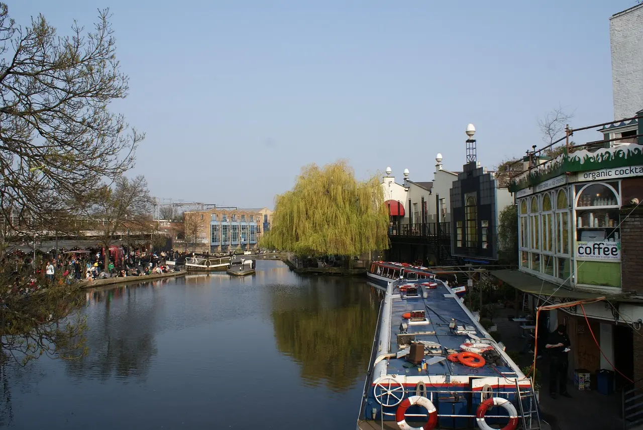 Colorful Camden Market stalls along Regent's Canal with boats and street art