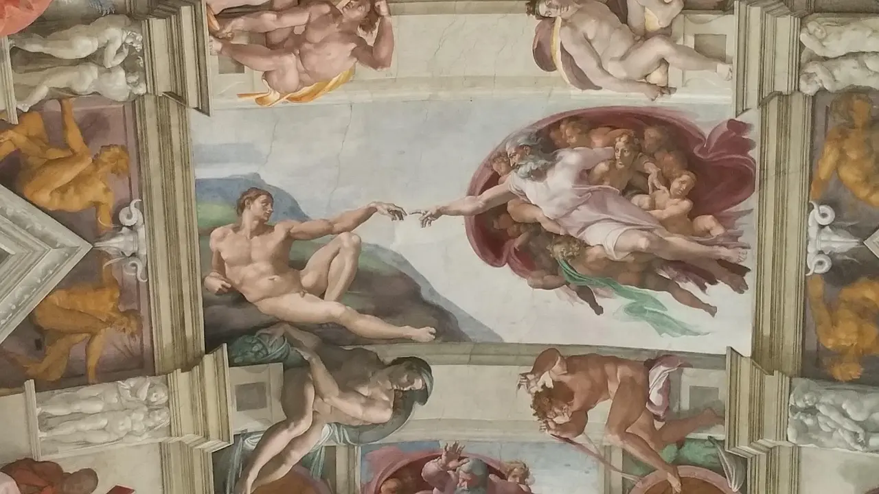 Interior of Sistine Chapel with Michelangelo's ceiling and visitors