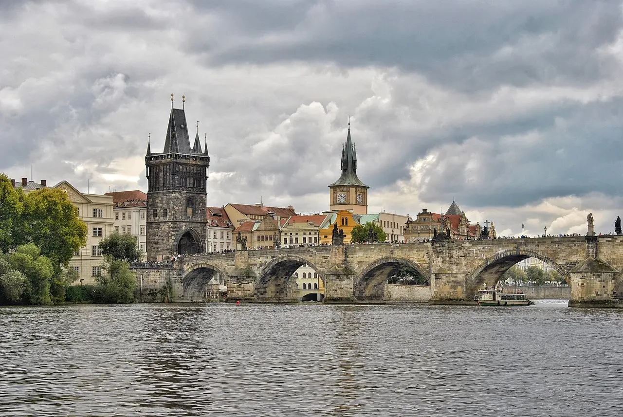 Charles Bridge in Prague at dawn with statues and river below